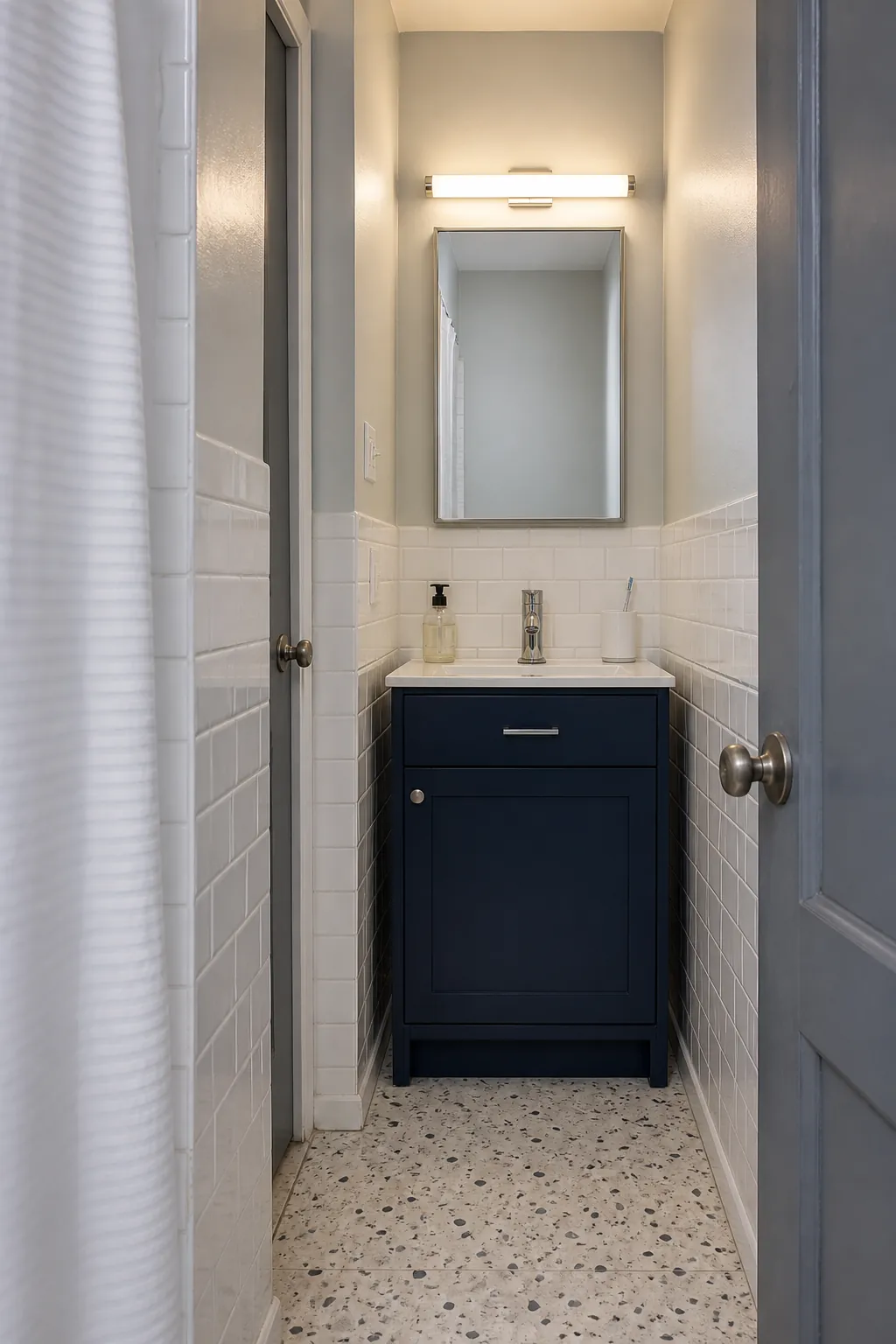 Frosted light bar above a narrow bathroom vanity