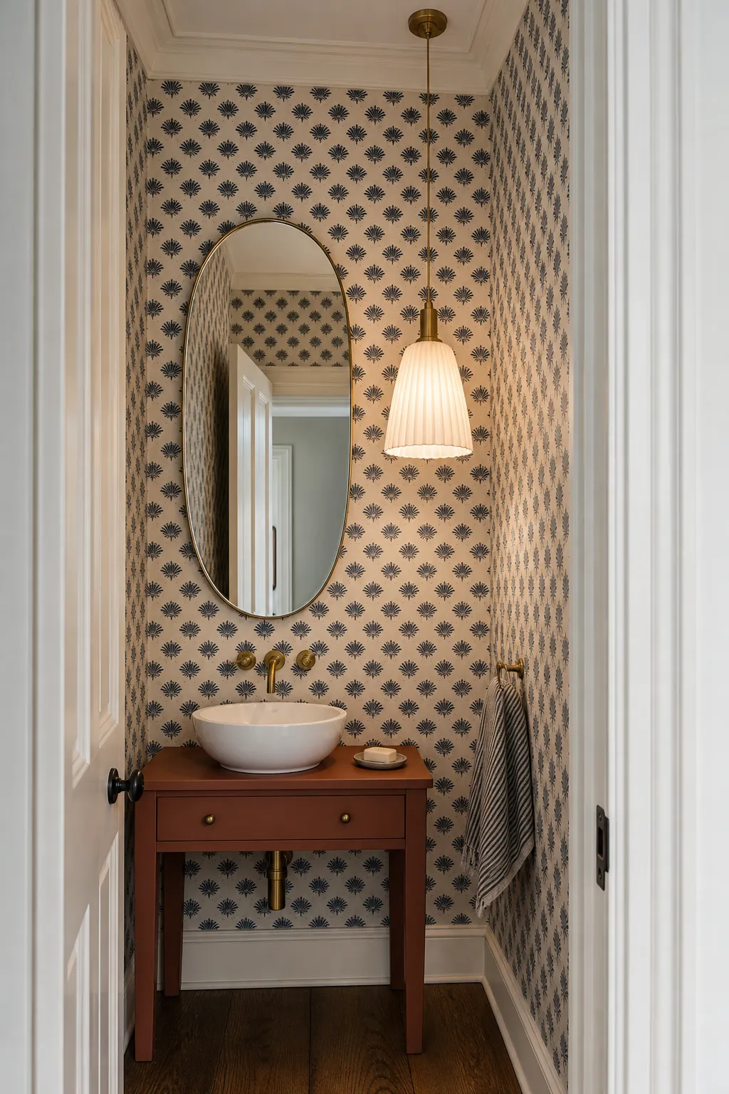 Soft pendant light beside an offset bathroom vanity mirror