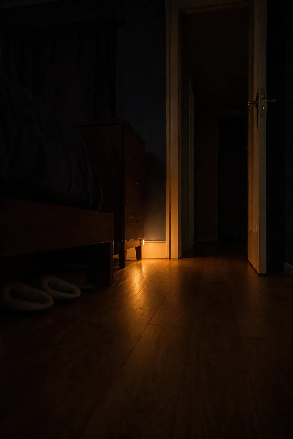 Low amber nightlight marking a safe path beside the bed