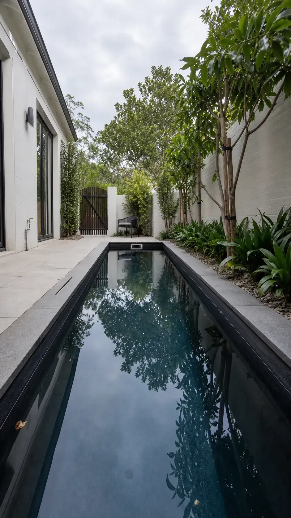 use a dark interior to strengthen the line in a long and narrow backyard pool layout