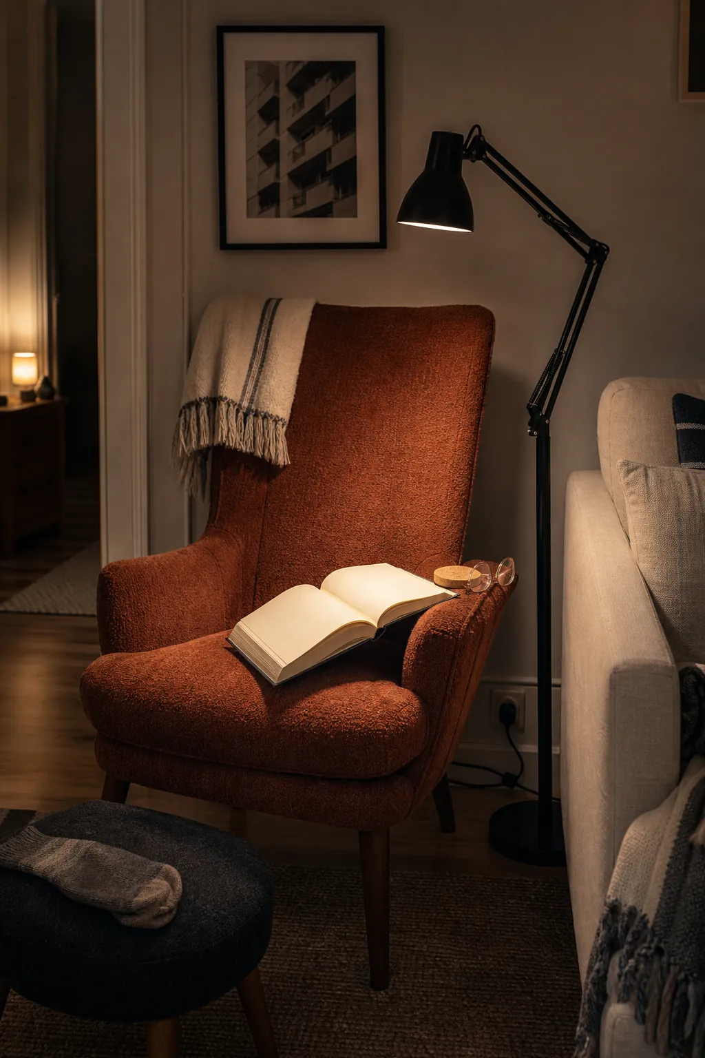 Adjustable floor lamp providing focused reading light beside a sofa in a small living room