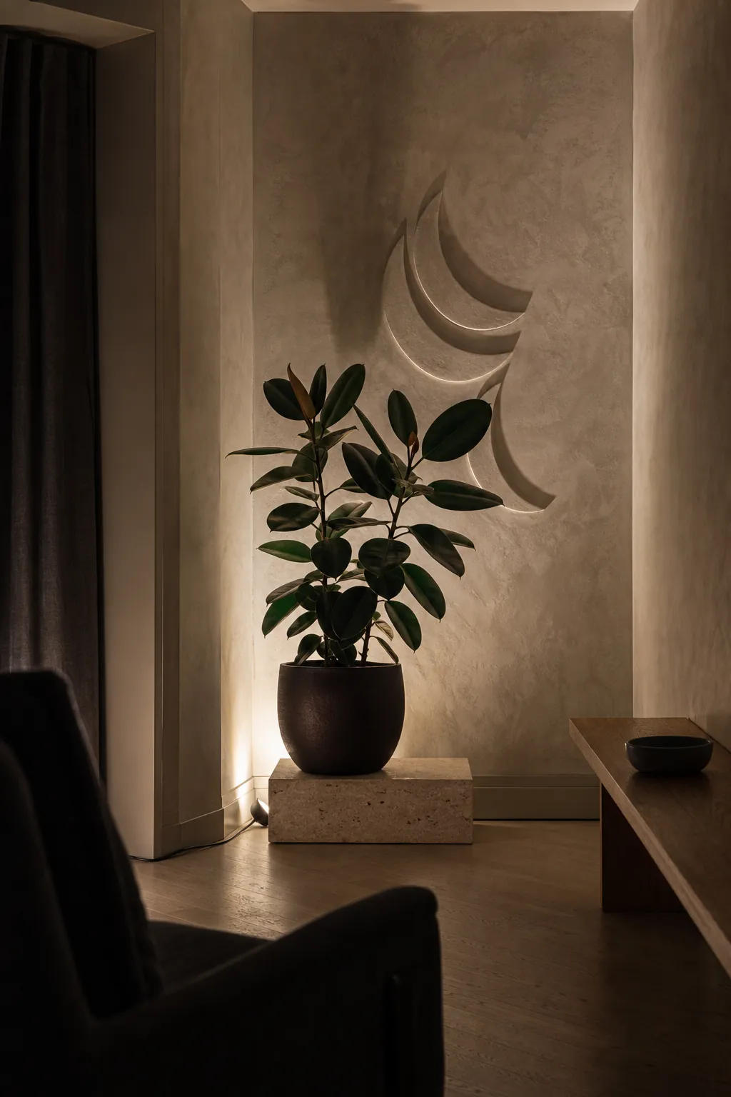 Subtle wall-wash accent light adding depth to the far corner of a small living room