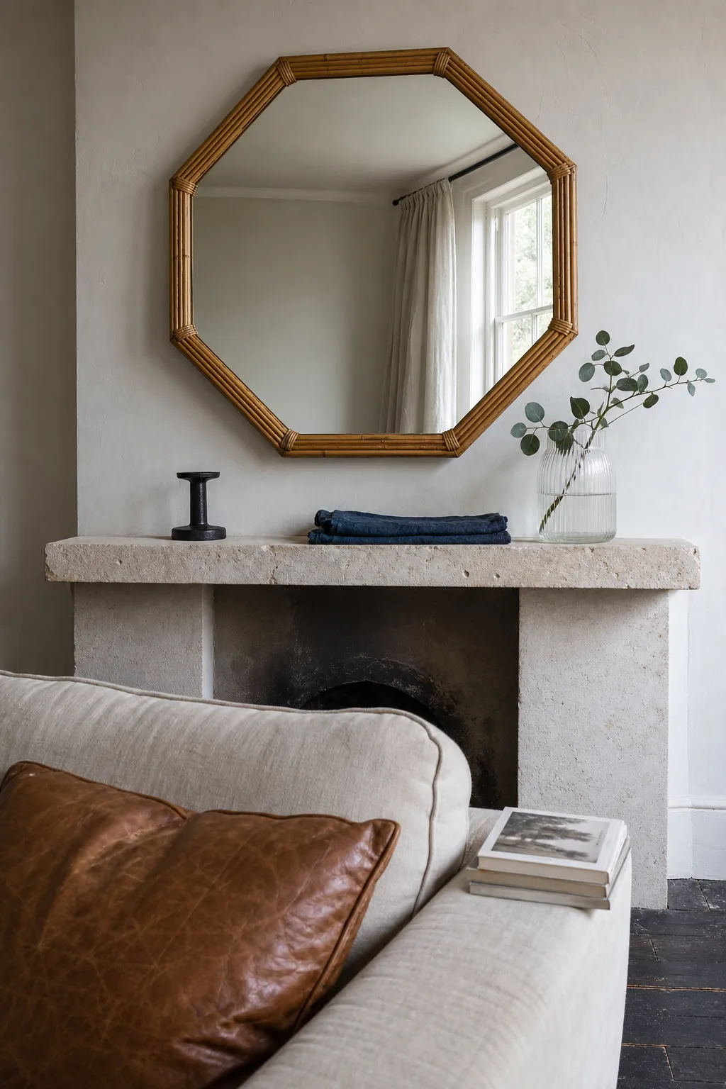 Bamboo mirror styled with limestone linen and dark metal accents