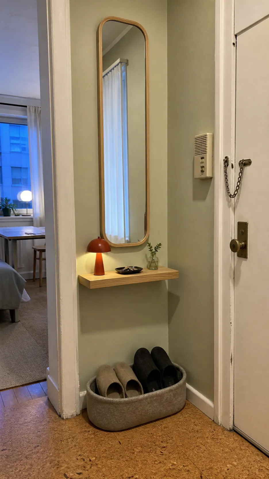 Small foyer styled with a tall mirror rechargeable lamp and compact basket