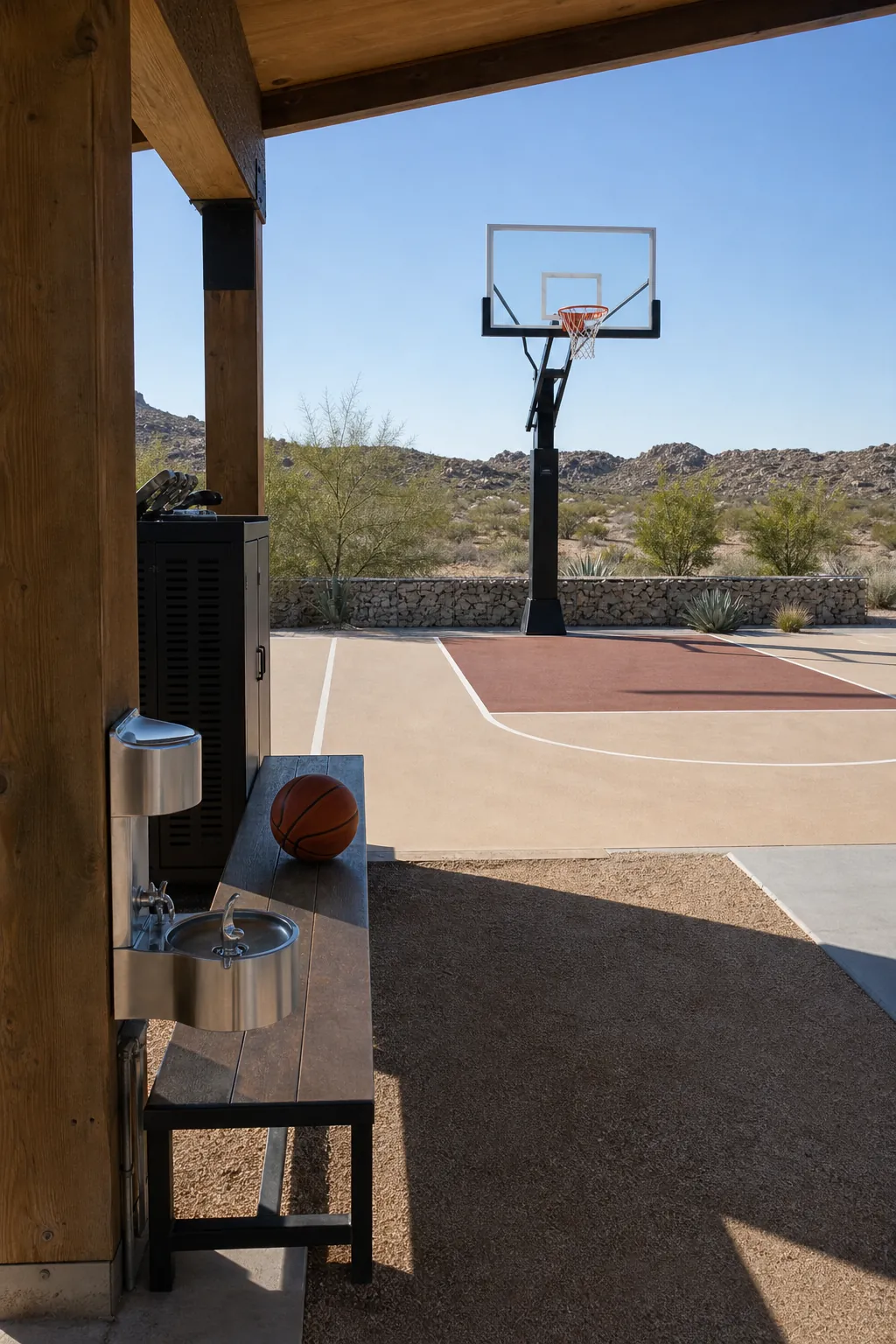 Desert house basketball court with a shaded ramada and pale playing surface