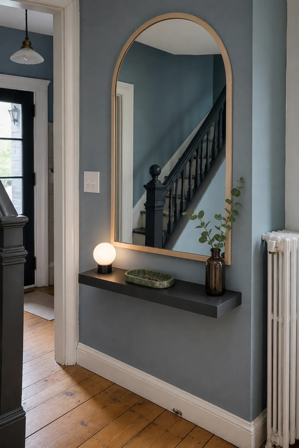 Arched entryway mirror hung at a connected height above a console