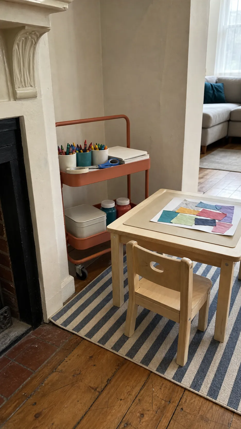 Compact art toy corner with a rolling supply cart in a living room alcove