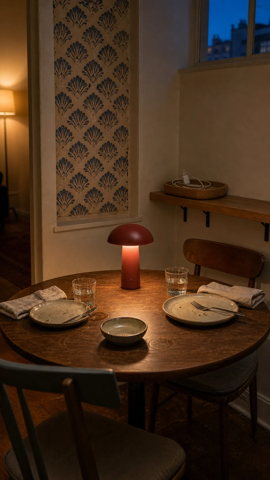 Rechargeable table lamp lighting a compact apartment dining nook