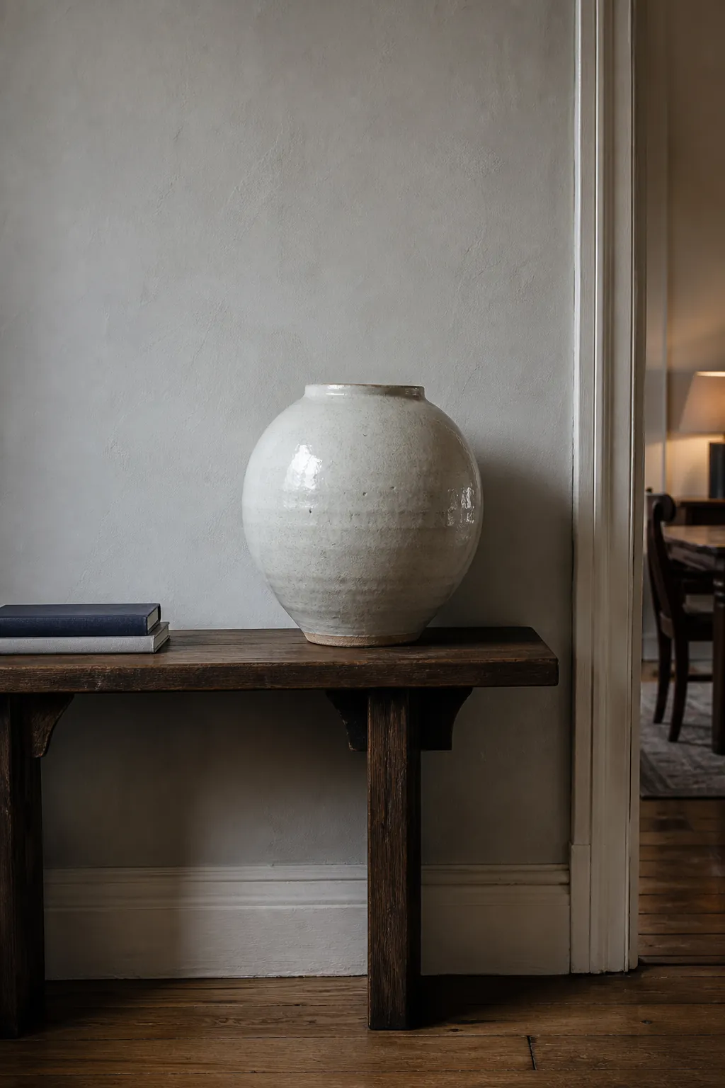 Handmade ceramic vessel displayed on a wood console