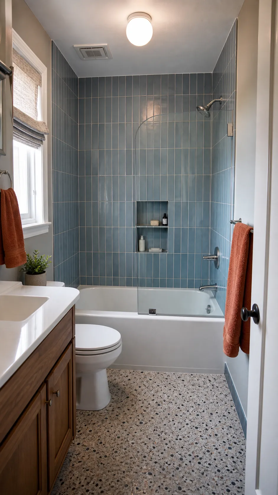 Small bathtub shower combo with ceiling-height vertical tile