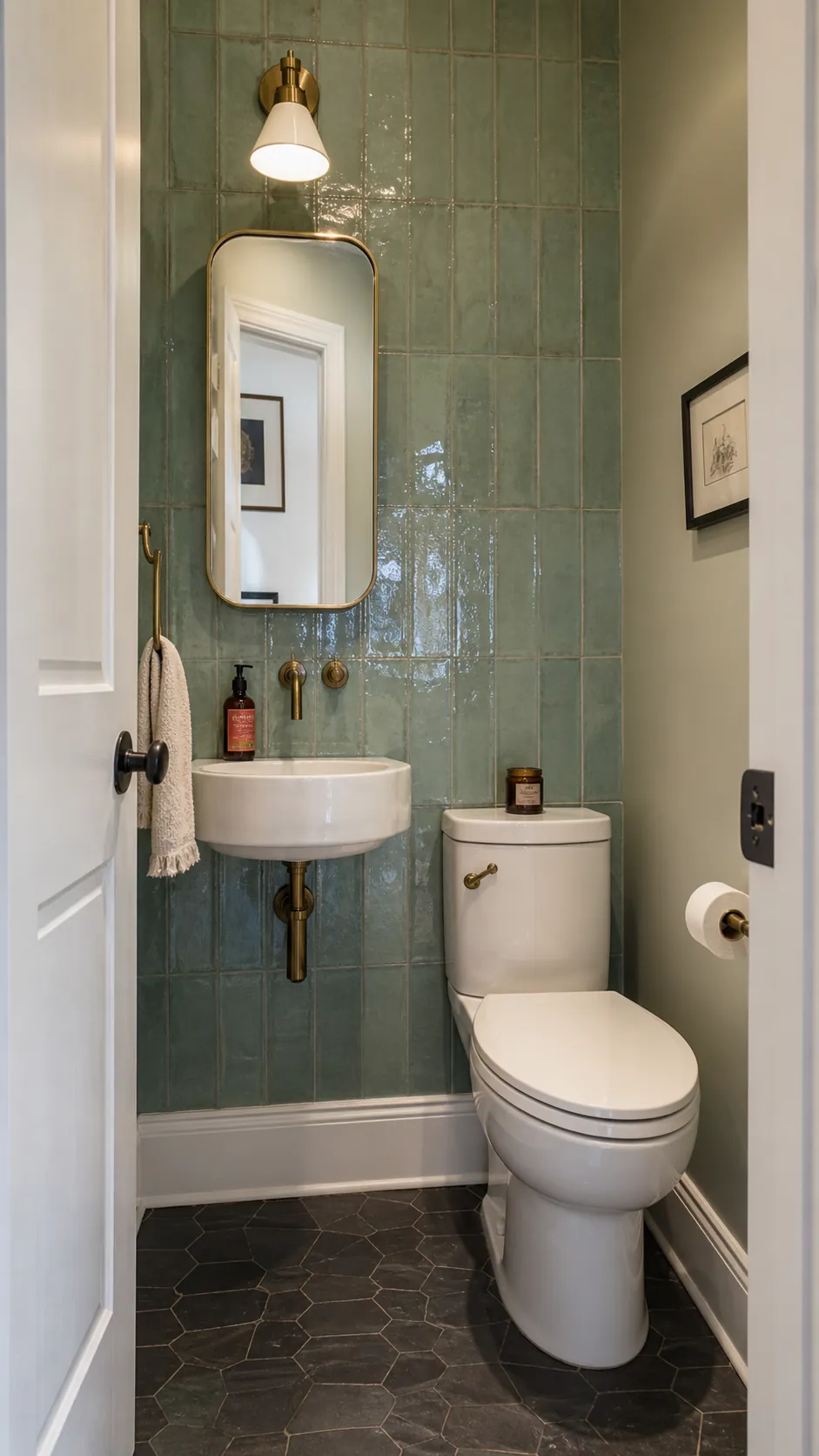 Reflective glazed tile on the sink wall of a tiny powder room