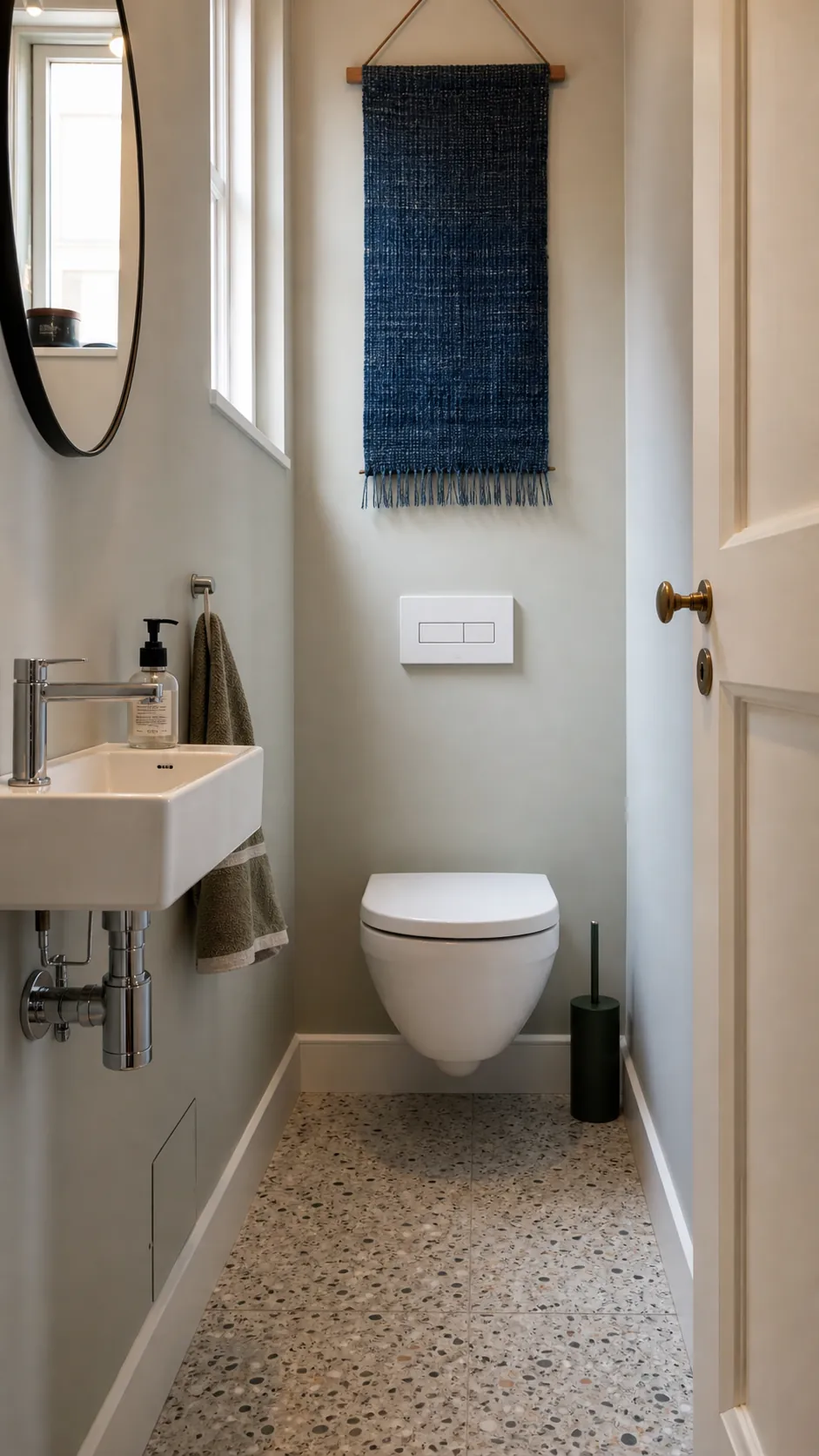 Compact wall-hung toilet in a minimalist tiny water closet