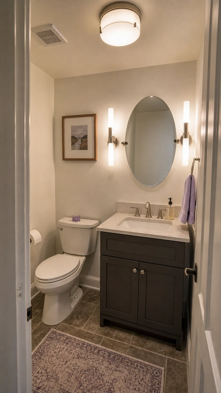 Layered sconces and ceiling light in a compact powder room