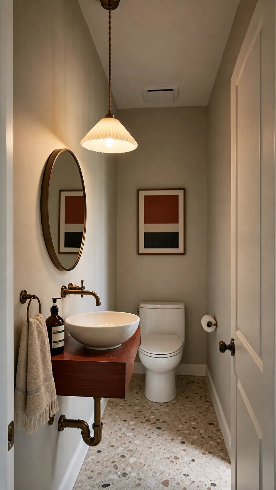 Small sculptural pendant lighting a compact powder room