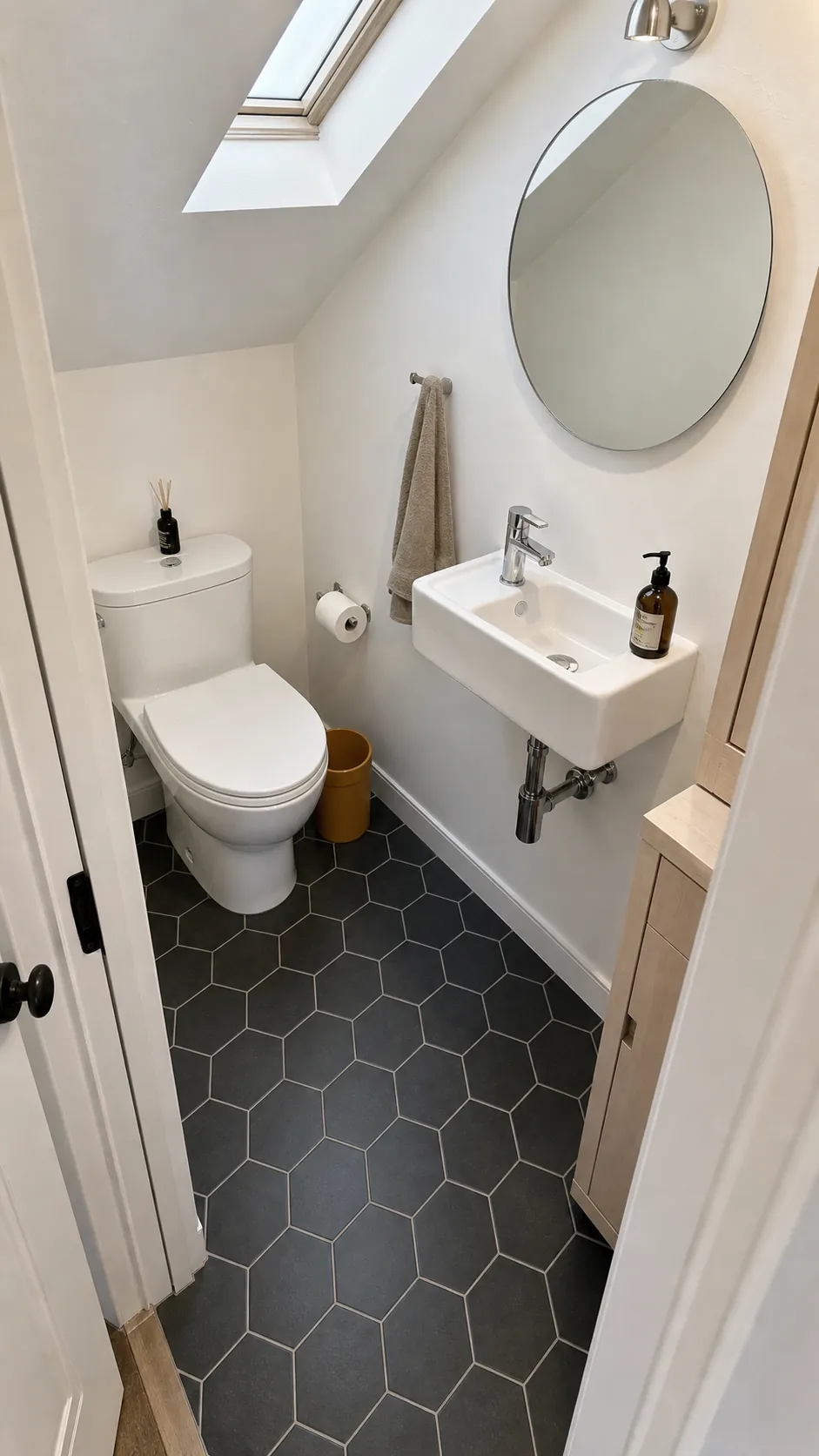 Dark charcoal floor grounding a bright tiny half bathroom