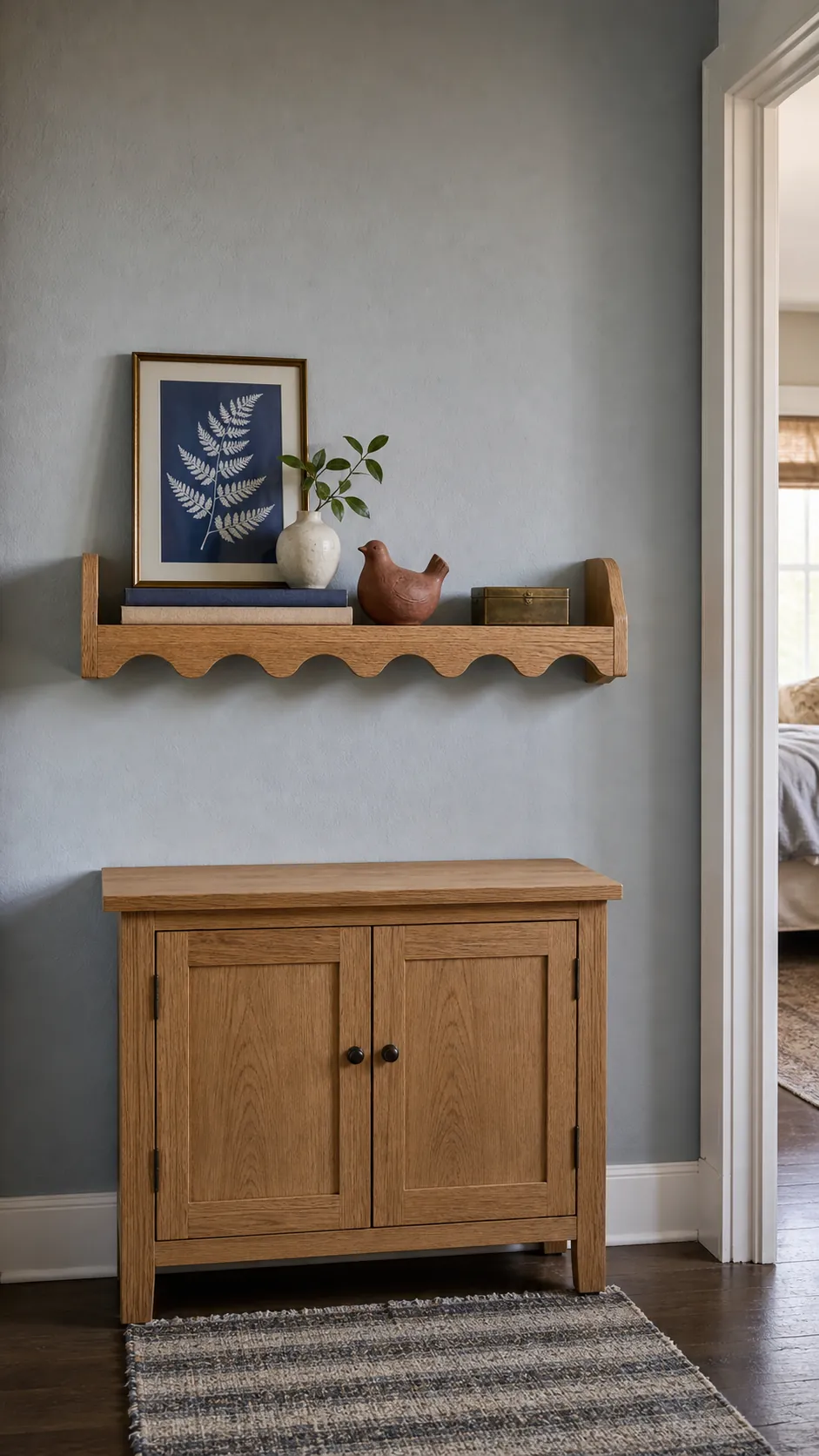 Thoughtfully styled scalloped shelf with books ceramic and personal decor