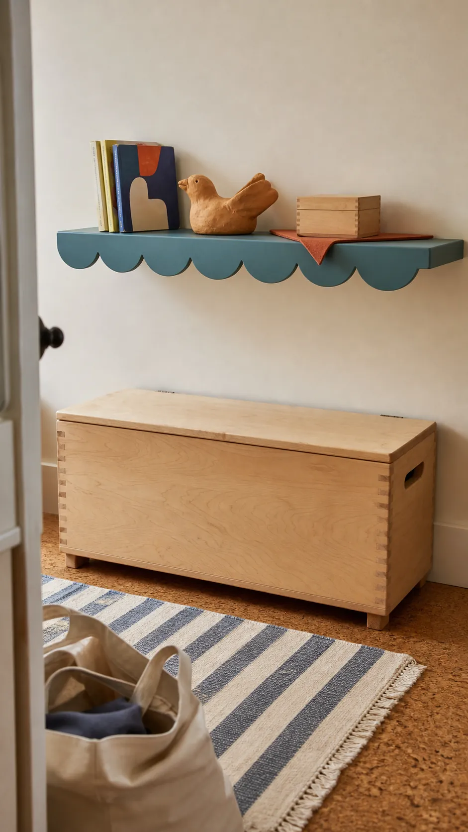 Child's handmade clay bird displayed with books on a scalloped shelf