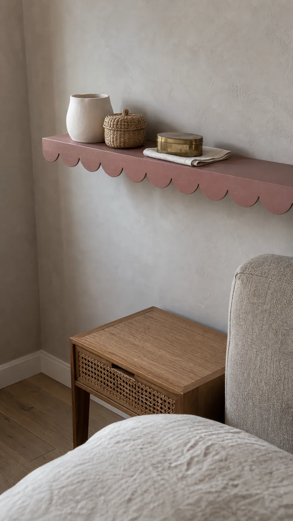 Small ceramic woven and brass decor mixed on a bedroom scalloped shelf