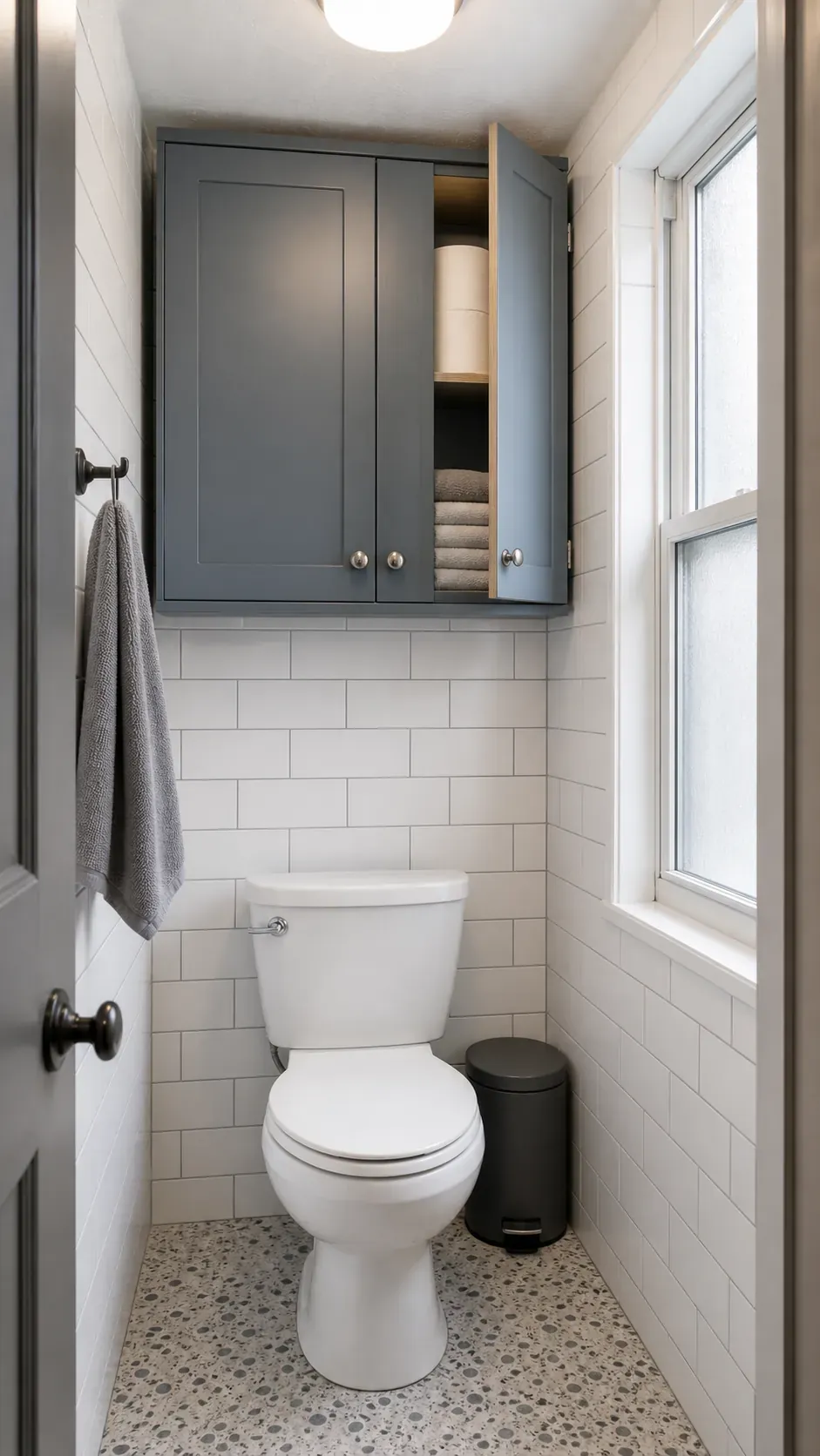 Tiny bathroom with shallow storage cabinet above toilet