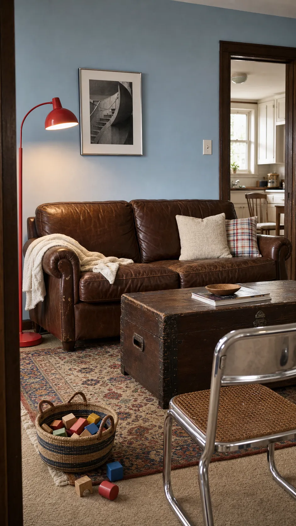 Vintage living room with a chocolate brown sofa, tomato red accents, and powder blue walls