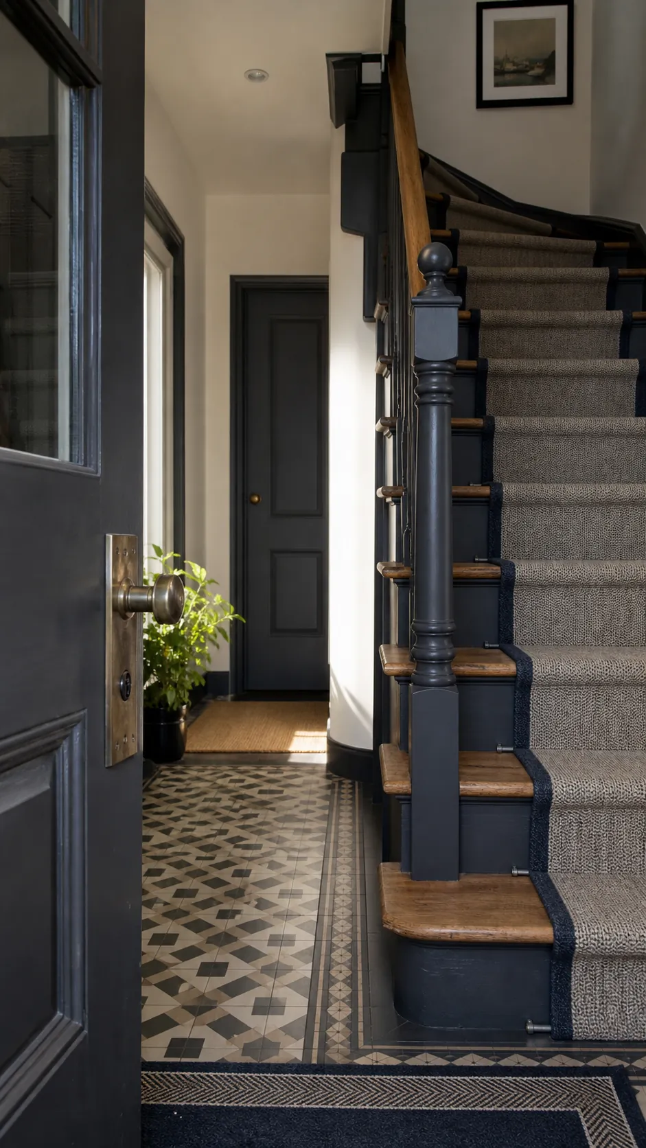 Front door and staircase connected by a cohesive color palette