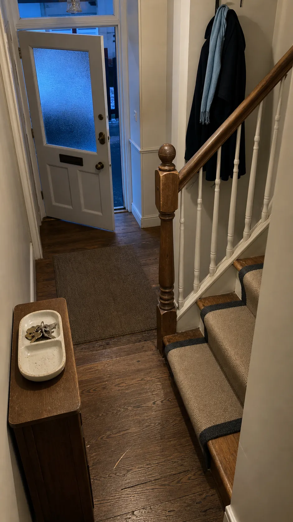 Clear and orderly stair entrance after an evening reset