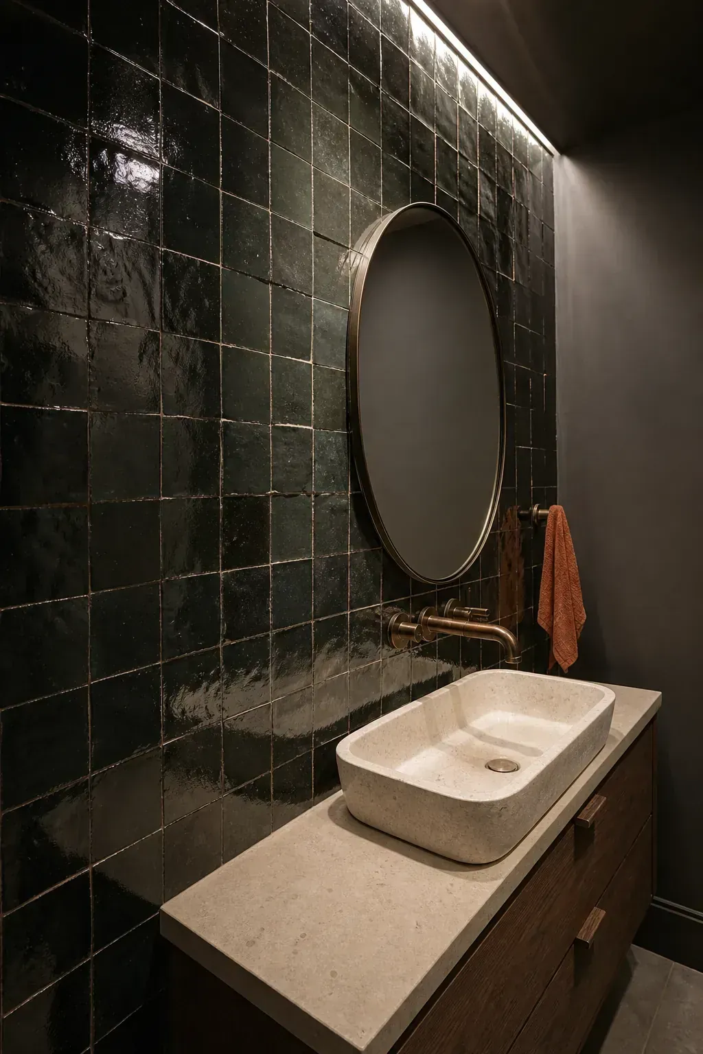 Glossy dark zellige tile vanity wall in a moody powder room