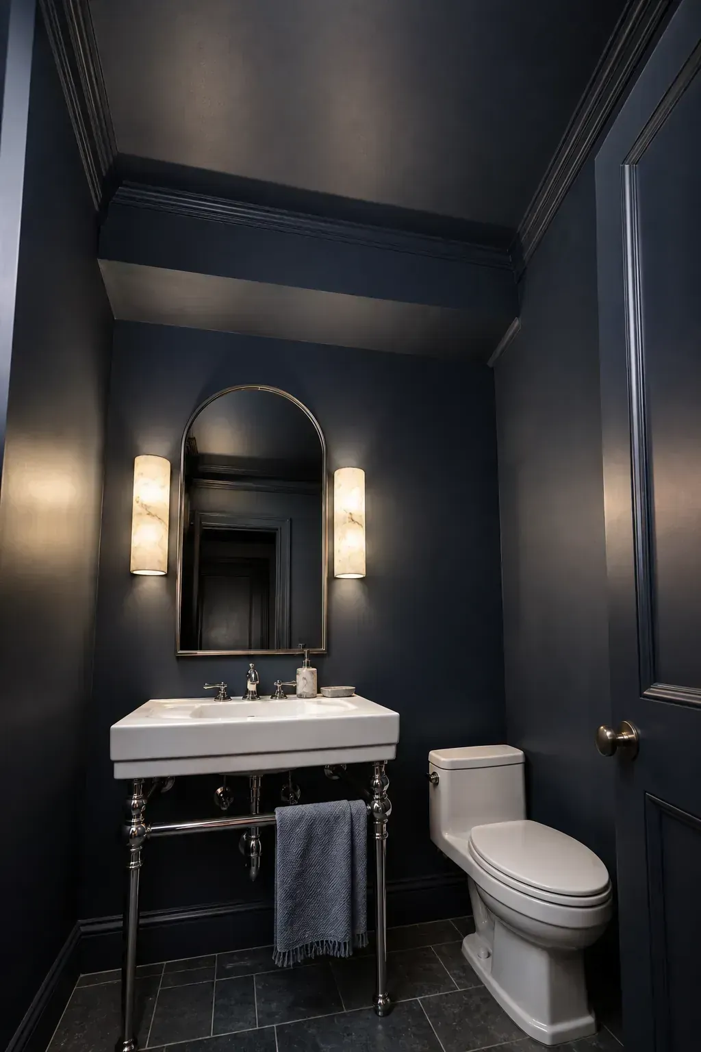 Moody half bath with walls and ceiling painted the same deep color