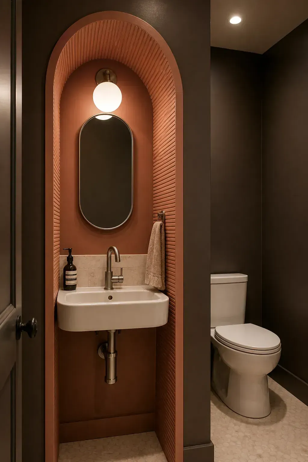 Fluted arched sink niche in a compact dramatic powder room
