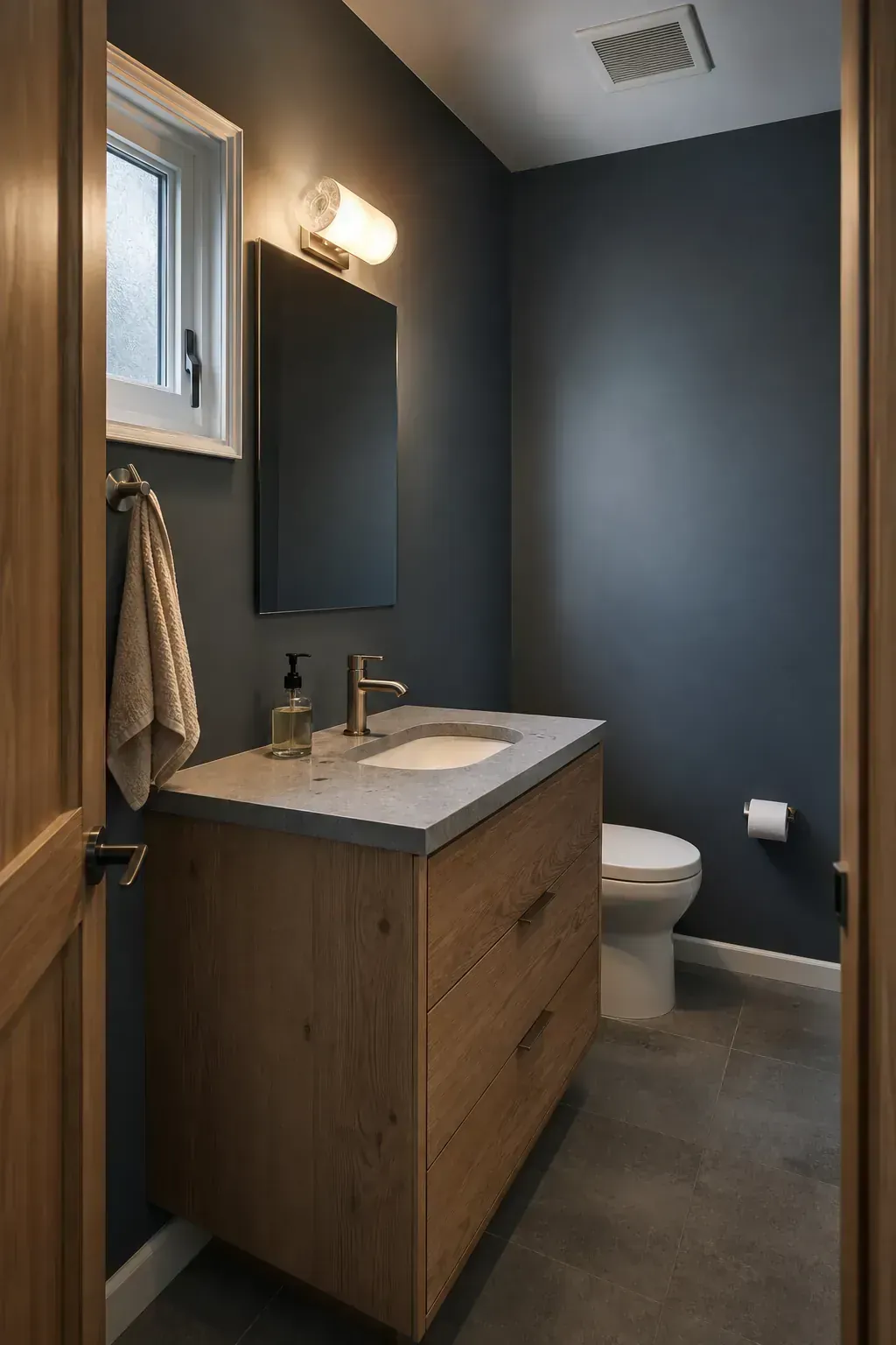 Quiet slate and oak moody half bathroom with practical warm lighting