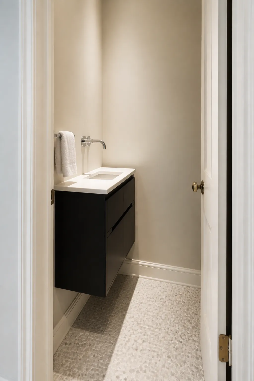 Slim black floating vanity in a small clean bathroom