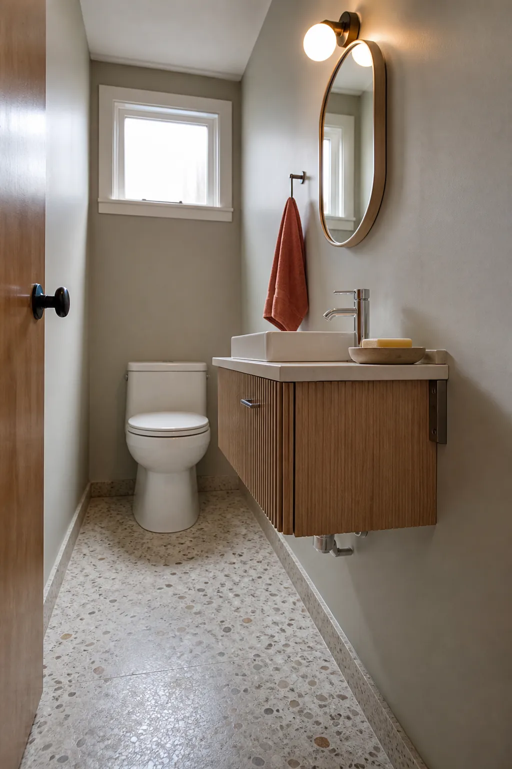 Shallow wall-hung vanity preserving floor space in a narrow half bathroom