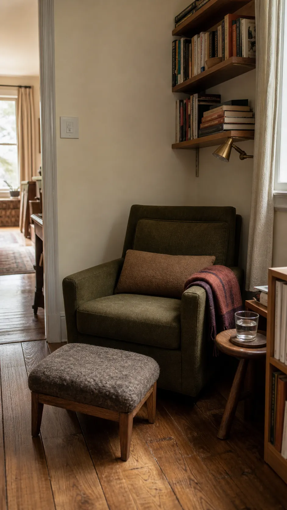 Supportive reading chair with lumbar cushion and footstool in a cozy book nook