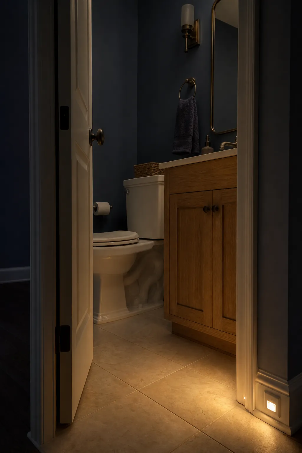 Gentle low-level night light guiding guests to a half bathroom