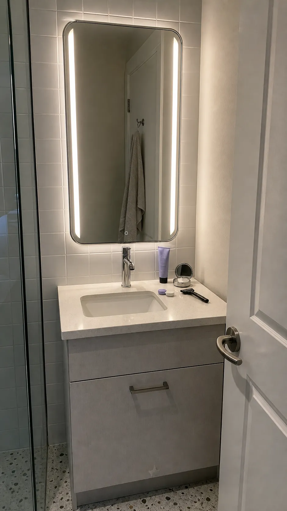 Front-lit LED bathroom mirror providing direct grooming light