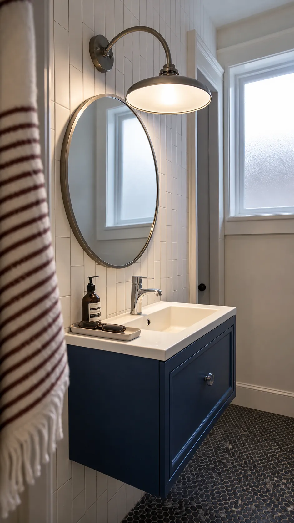 Round bathroom vanity mirror beneath a forward-reaching arc light