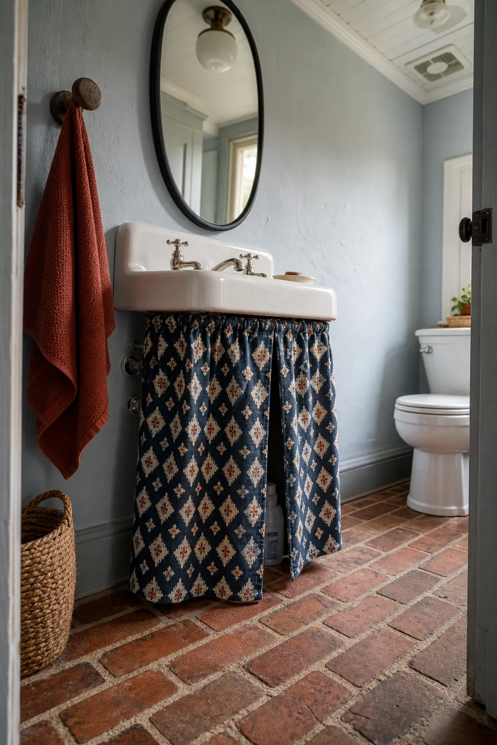 Charming half bath with a graphic fabric skirt below a wall-mounted sink