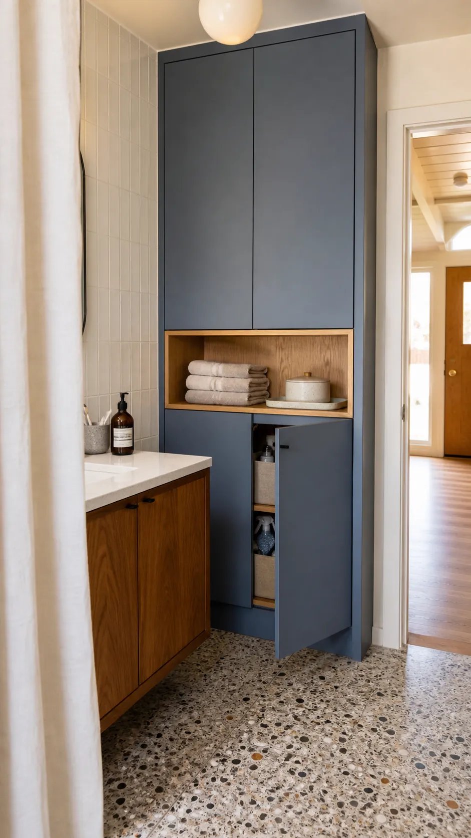 Tall bathroom cabinet with closed storage and one useful open towel niche