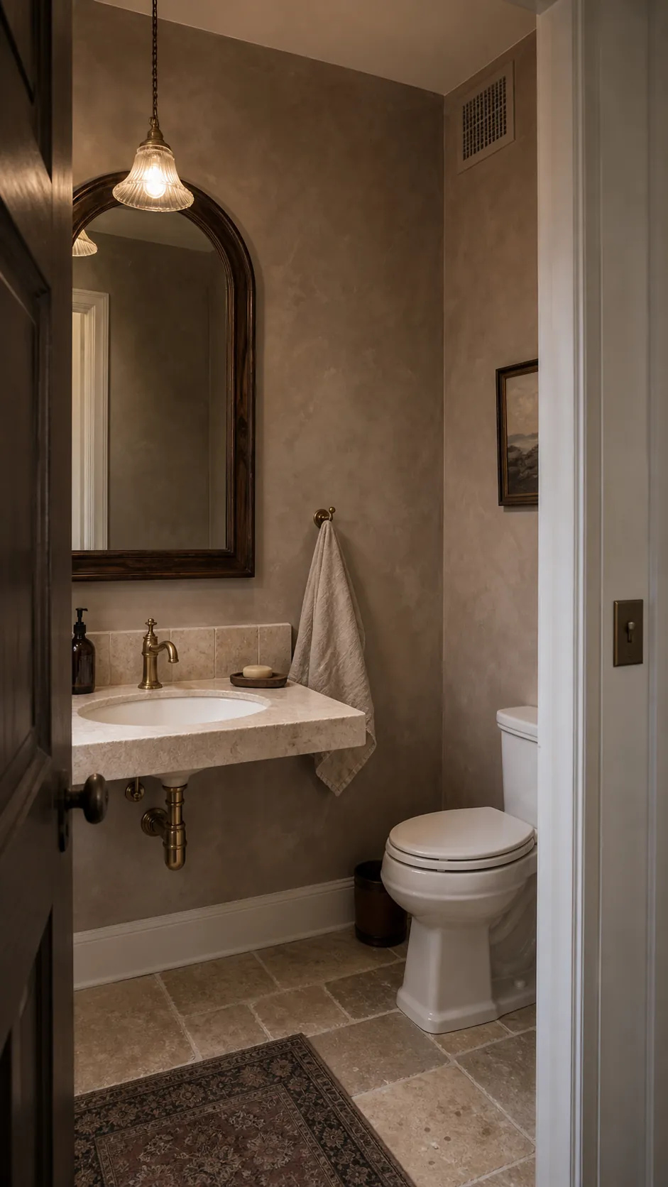 Rustic powder room with warm taupe limewash walls and a simple stone sink