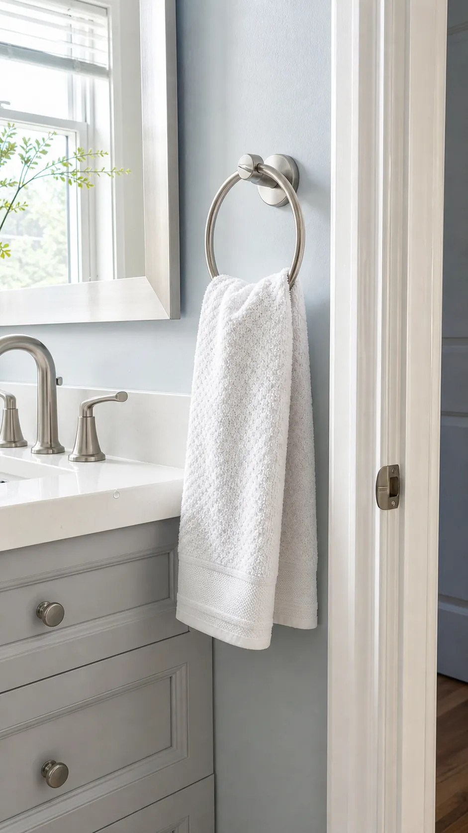 Hand towel ring placed conveniently beside a compact vanity