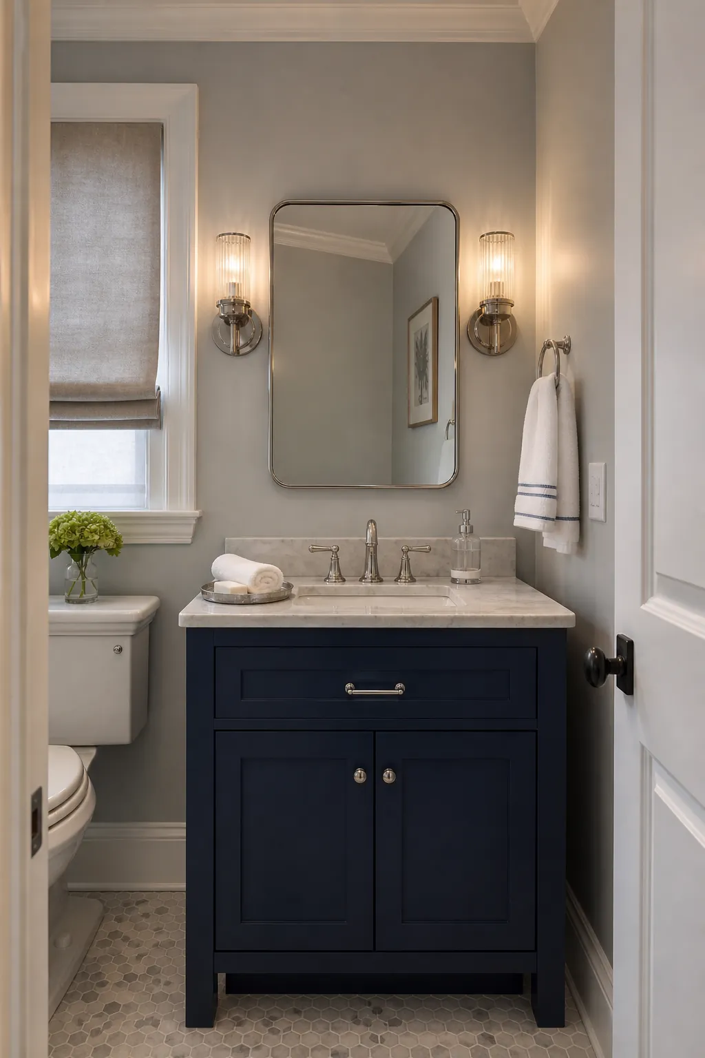 Elegant powder room vanity framed by two fluted glass sconces