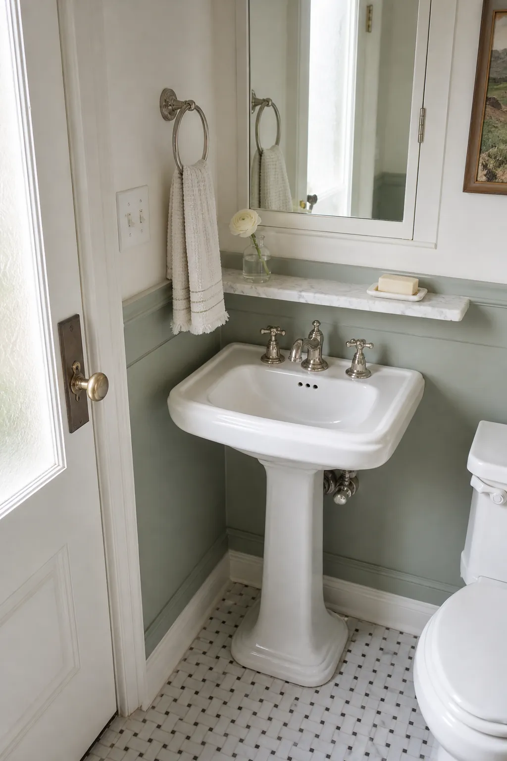 Elegant pedestal-sink powder room with a slim marble utility shelf
