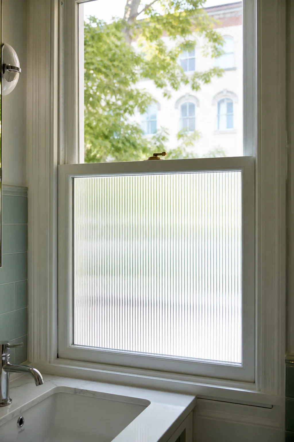 Bathroom vanity window with reeded privacy film on lower glass