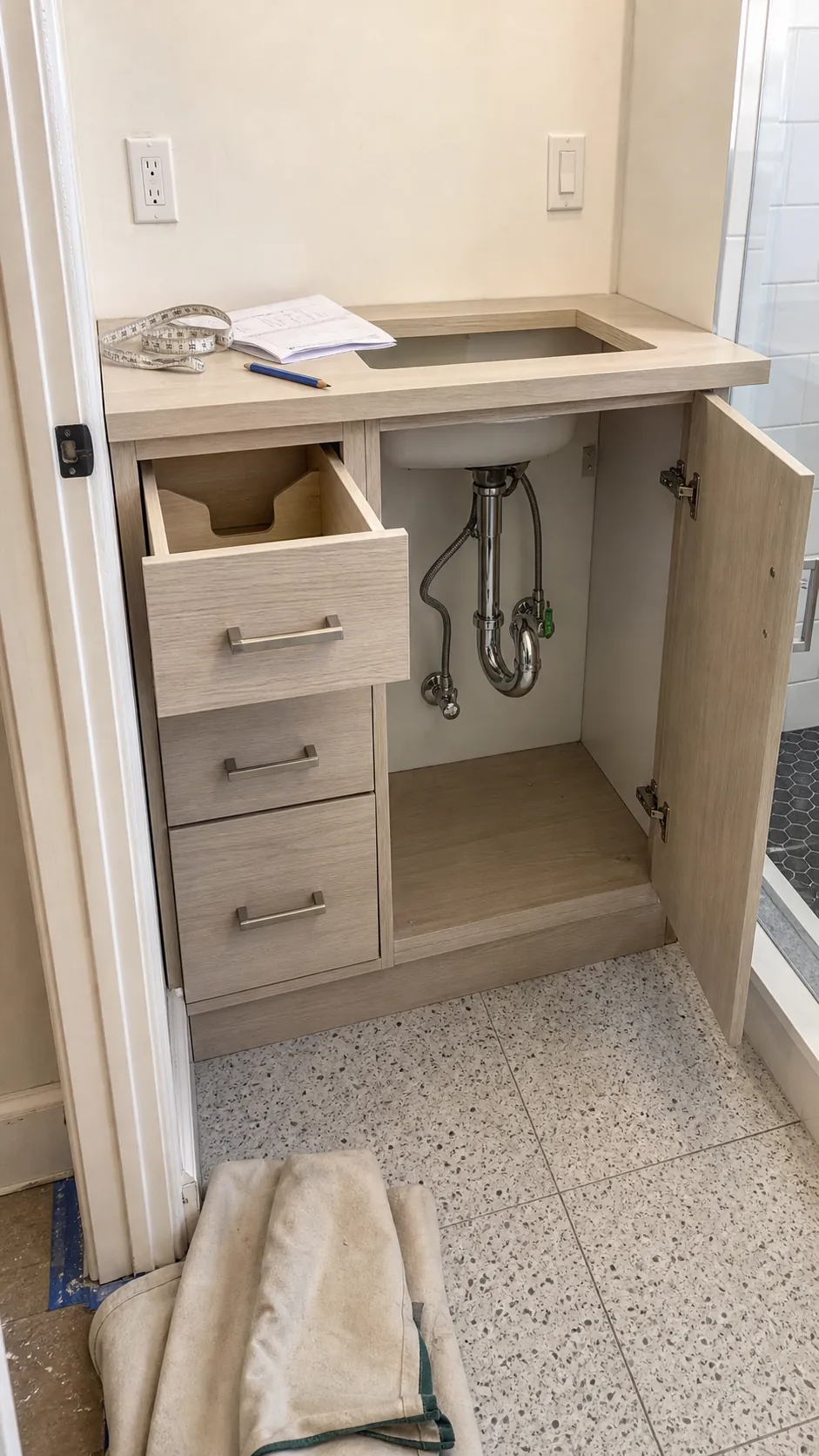 Bathroom vanity side drawers planned around visible sink plumbing clearances