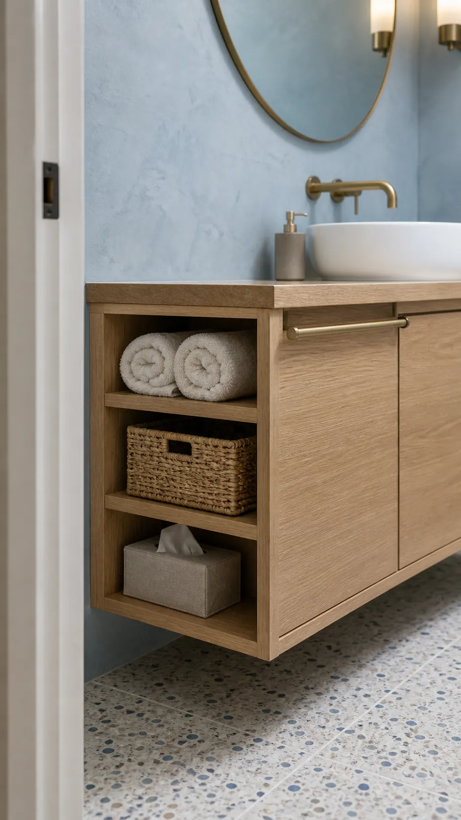Bathroom vanity exposed side with built-in towel cubbies and basket storage