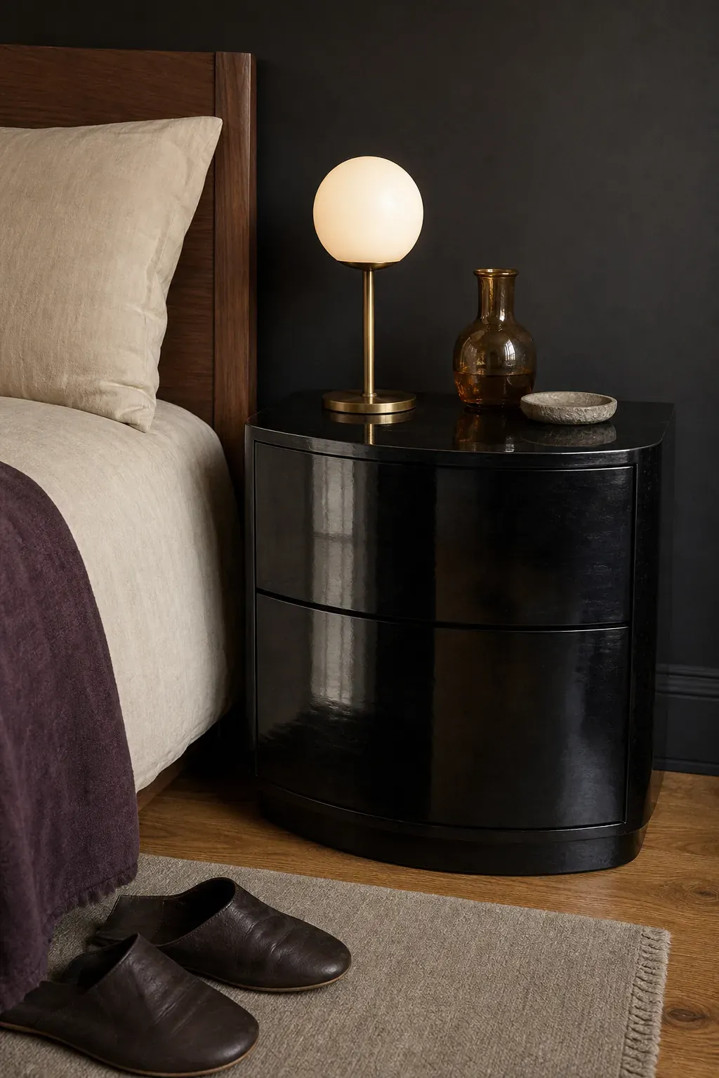 Curved lacquered black nightstand beside a romantic bed