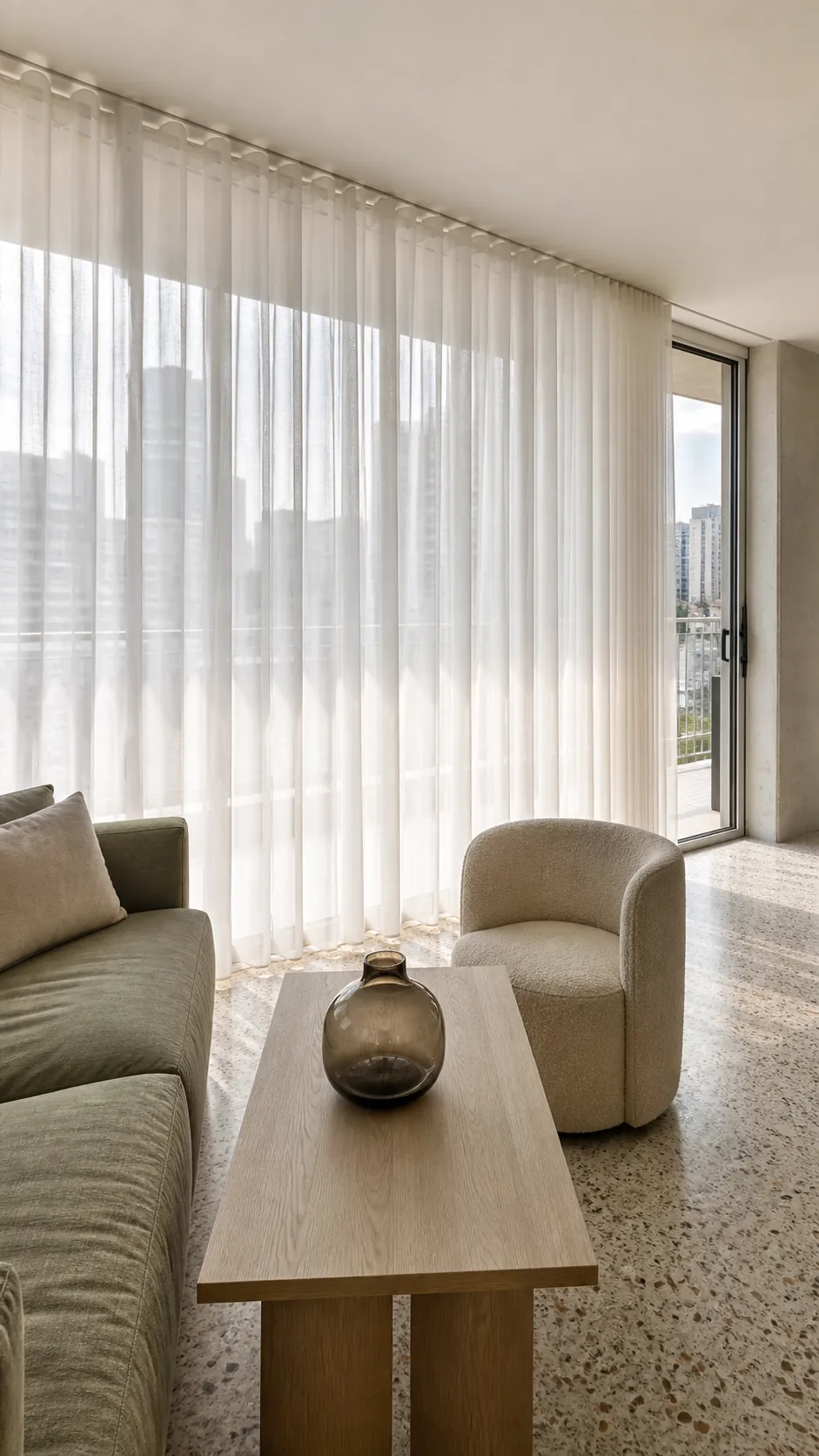 Full-wall sheer curtains diffusing daylight across a modern room