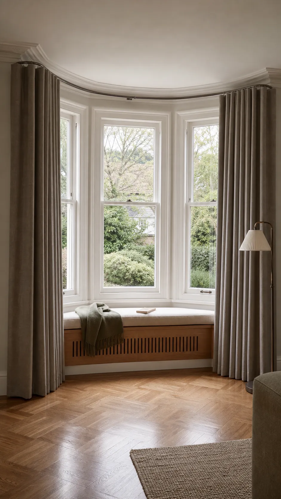 Soft curtains following a curved track around a bay window