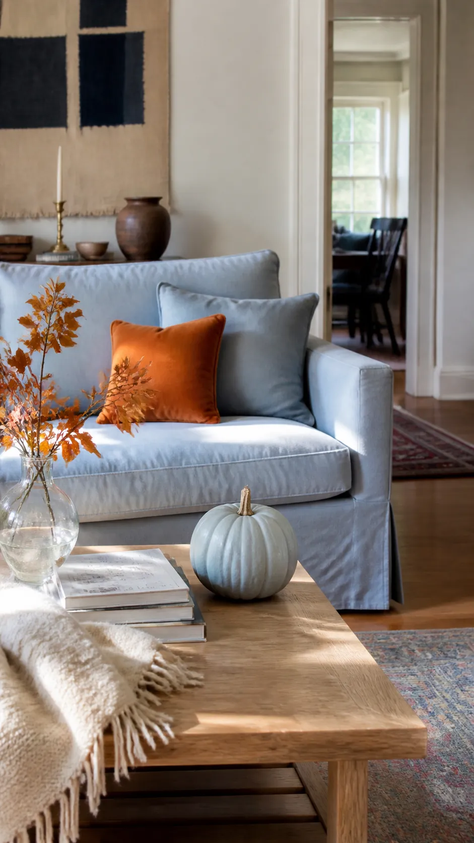 Light blue living room with refined orange fall decor