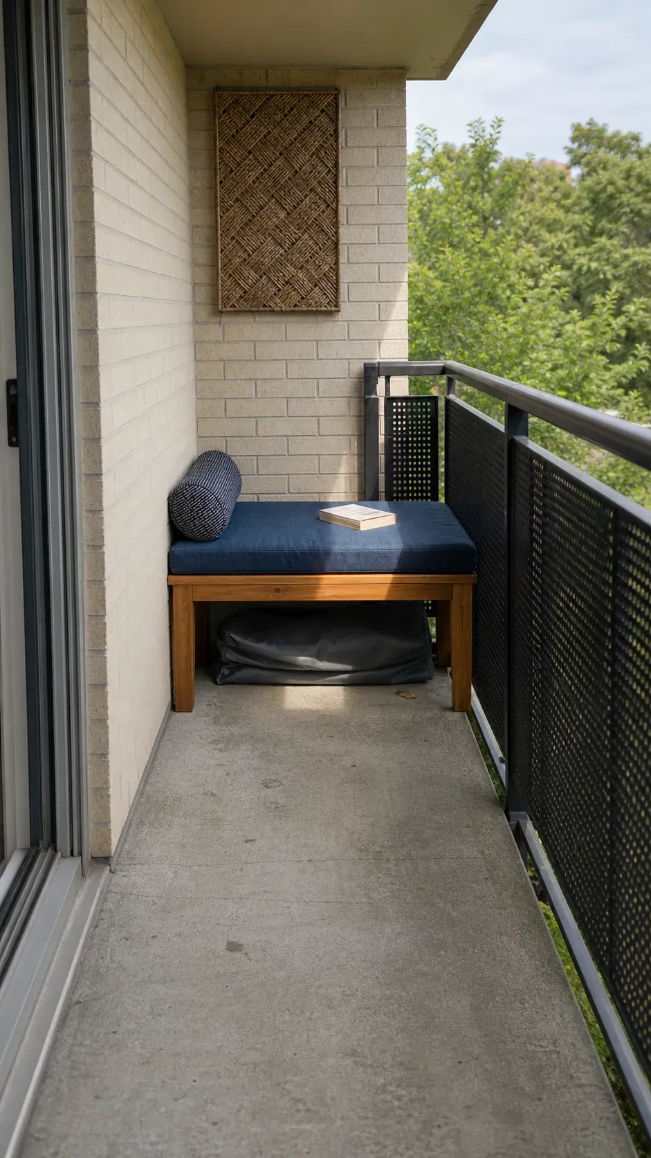 Slim bench fitted across the short end of a narrow apartment balcony
